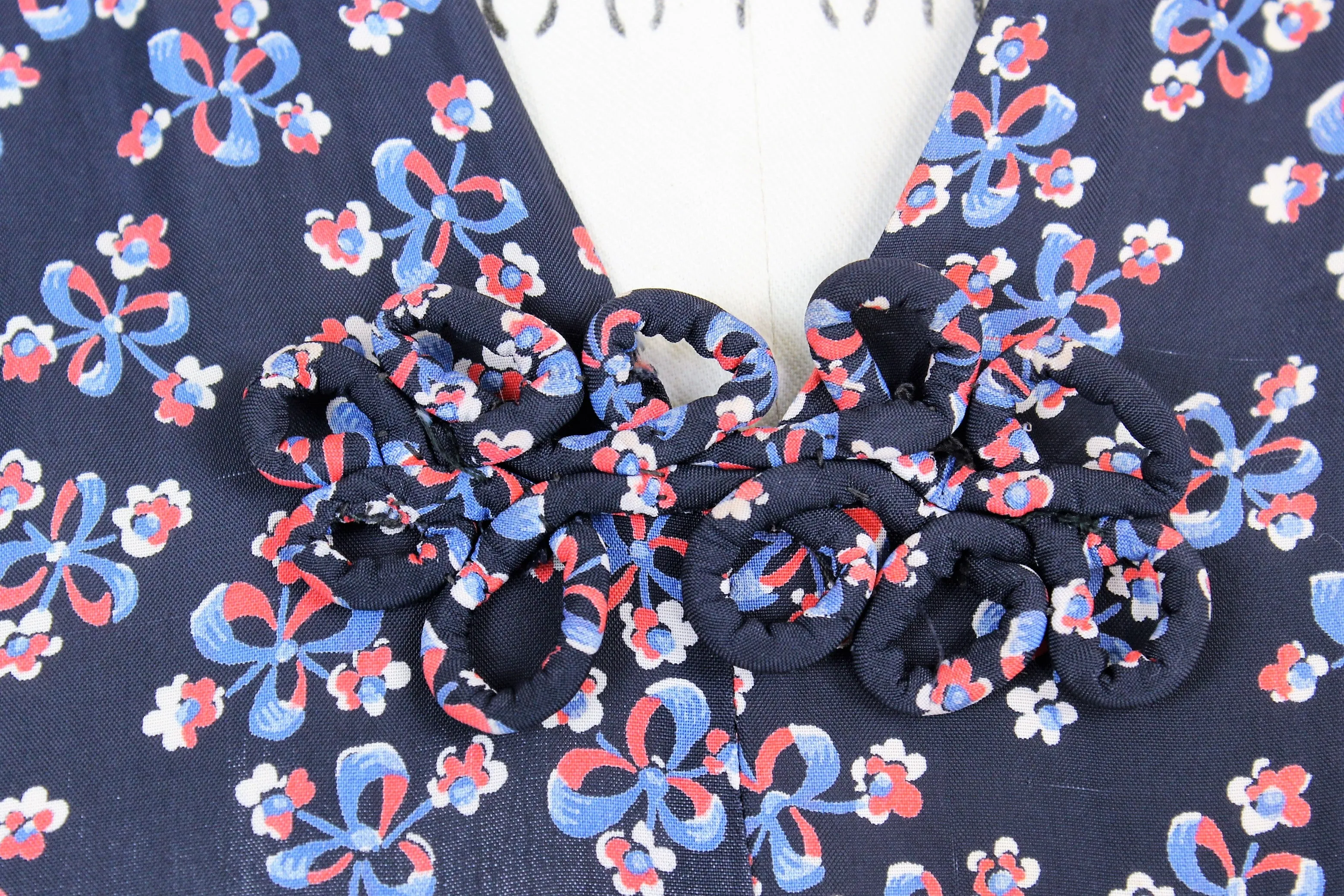 Vintage 1940s Rayon Day Dress With A Floral And Bow Print In Red White And Blue