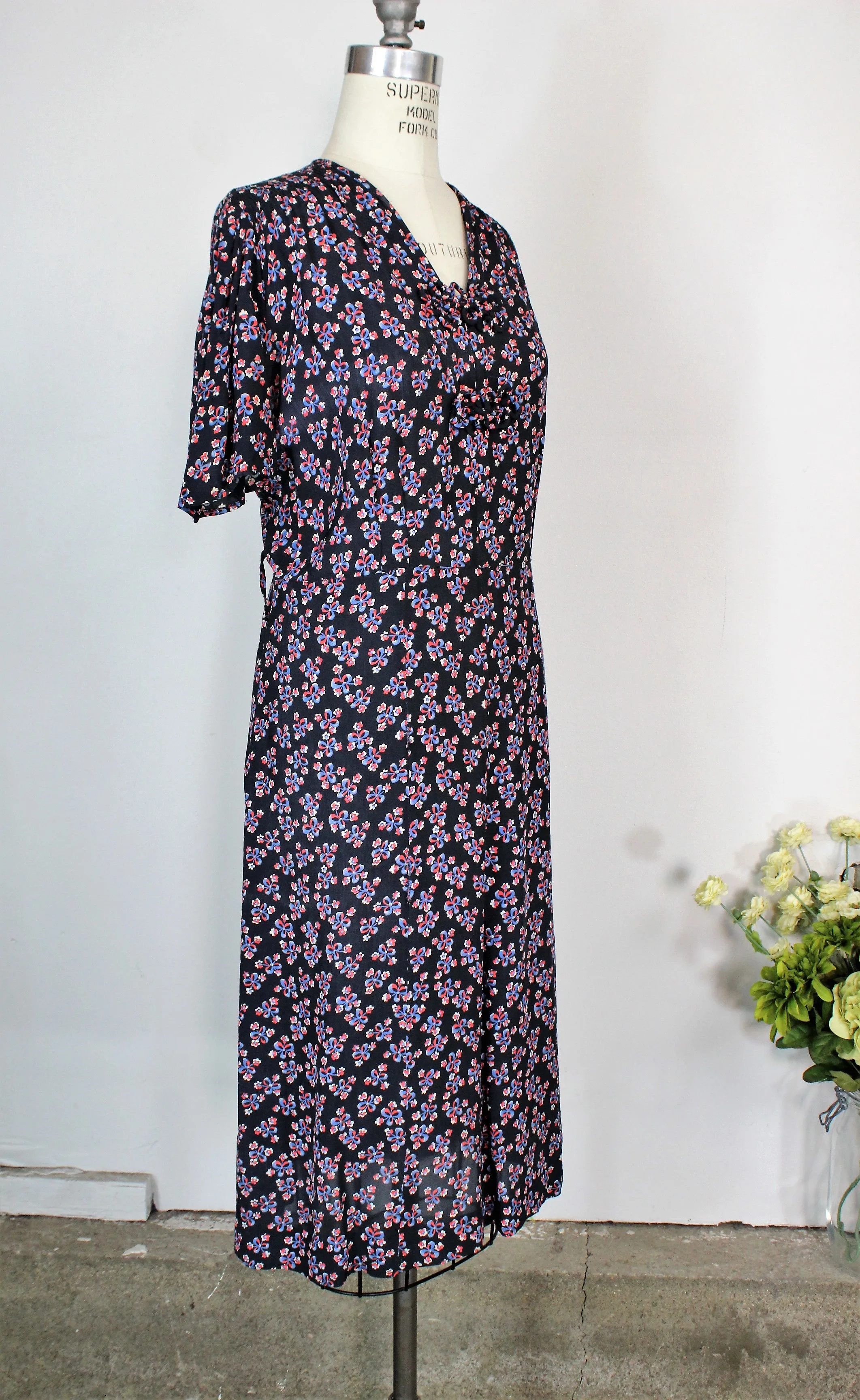 Vintage 1940s Rayon Day Dress With A Floral And Bow Print In Red White And Blue