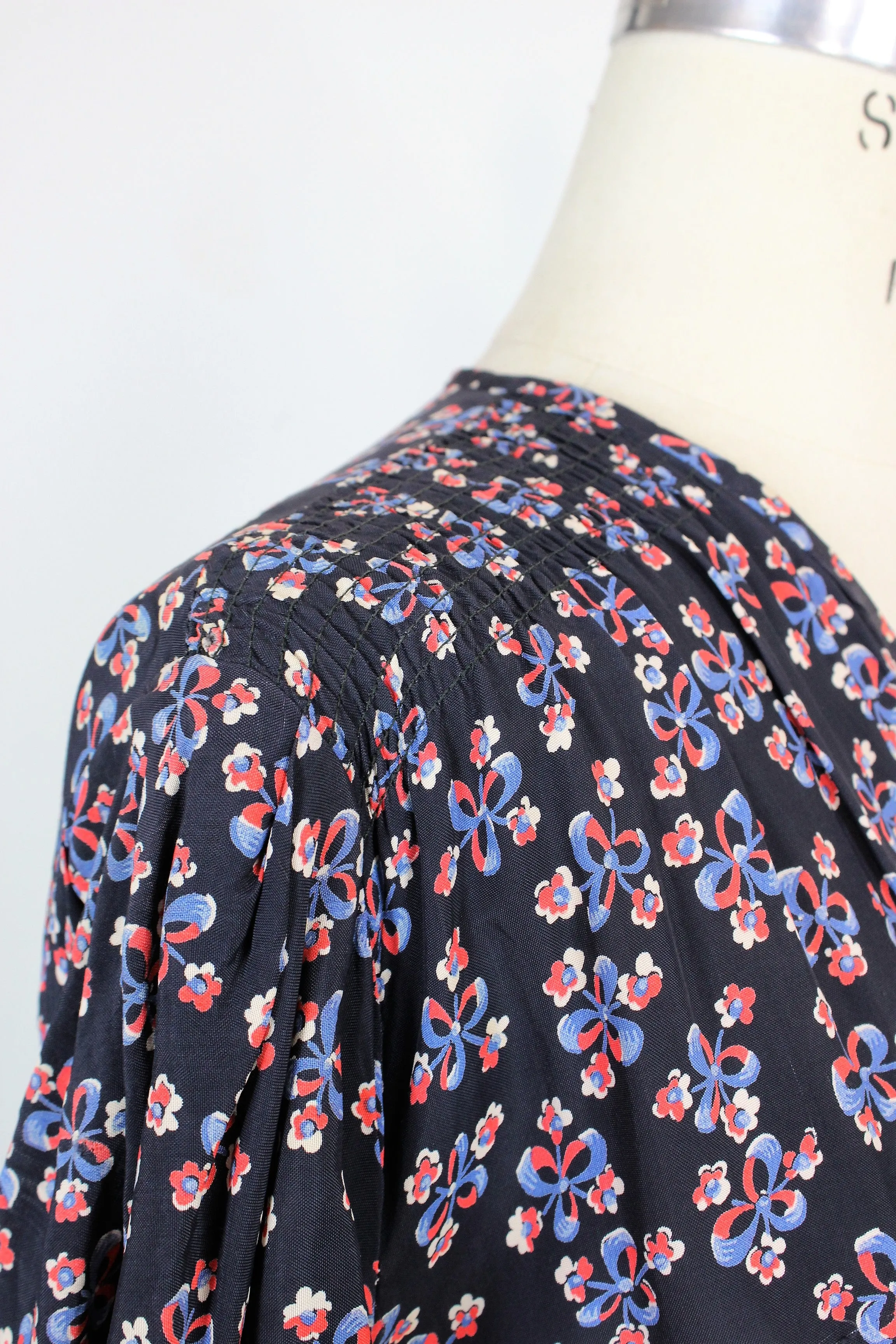 Vintage 1940s Rayon Day Dress With A Floral And Bow Print In Red White And Blue