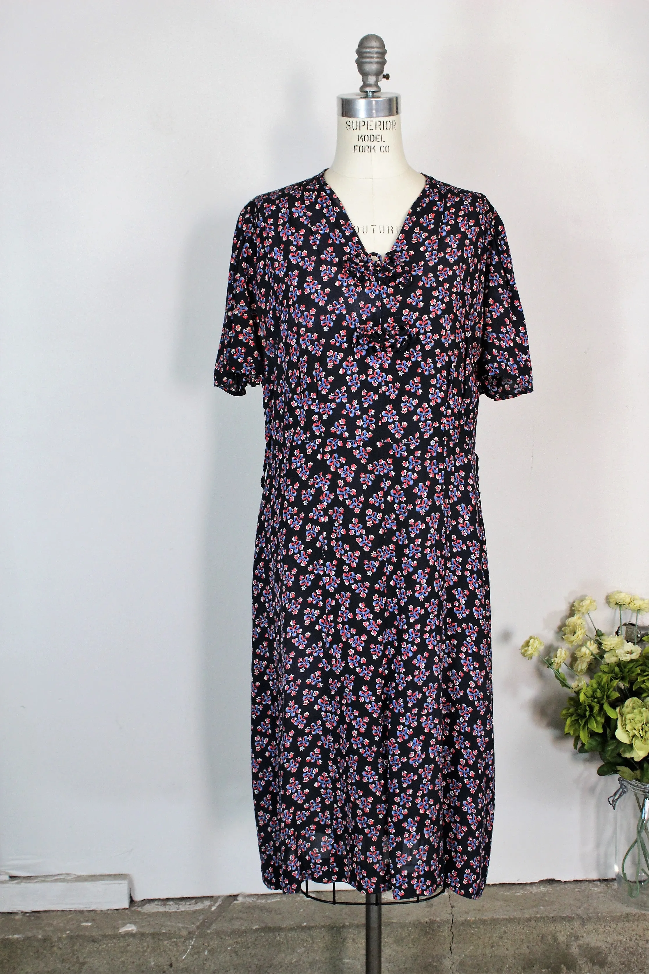 Vintage 1940s Rayon Day Dress With A Floral And Bow Print In Red White And Blue