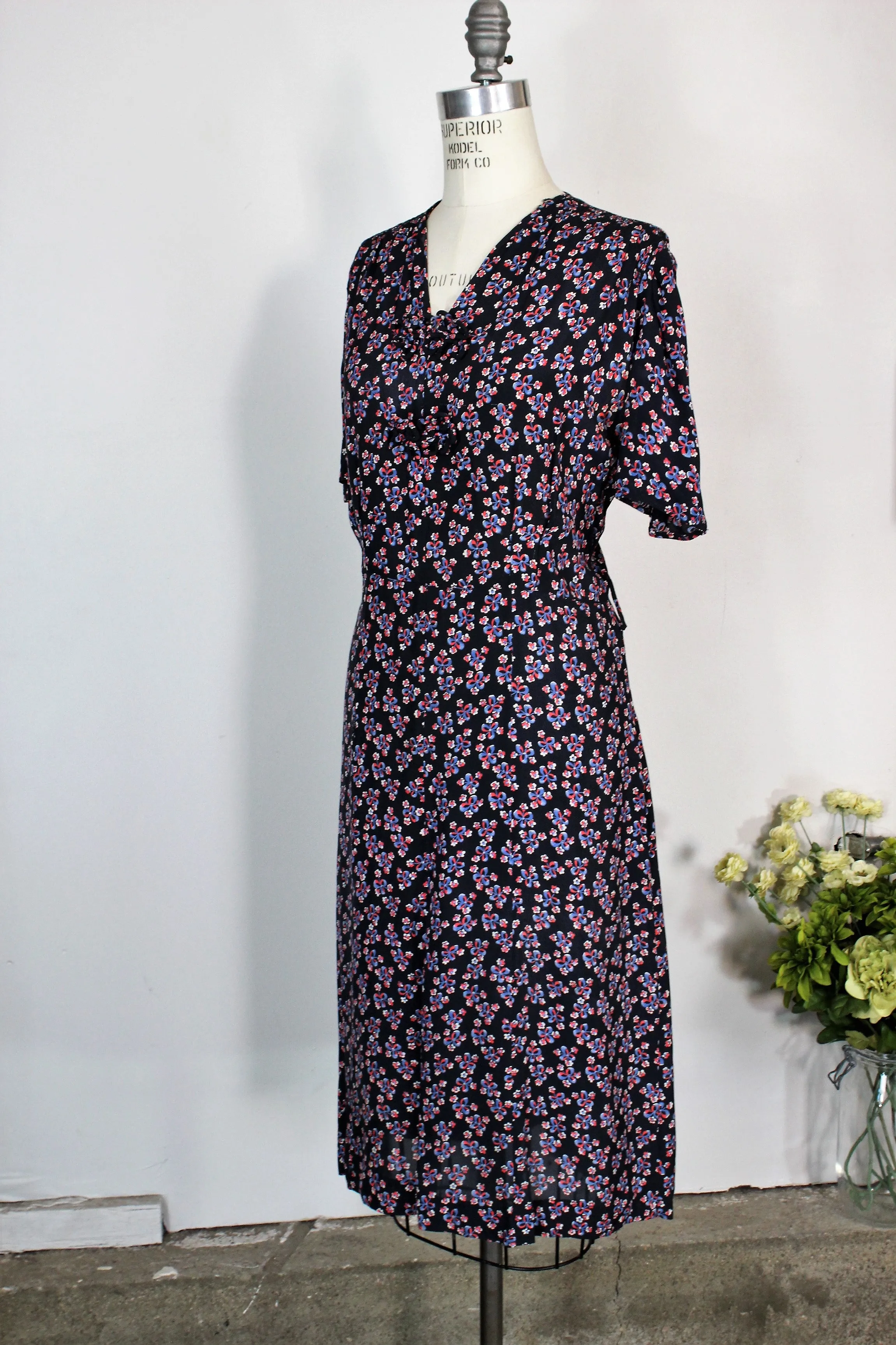Vintage 1940s Rayon Day Dress With A Floral And Bow Print In Red White And Blue
